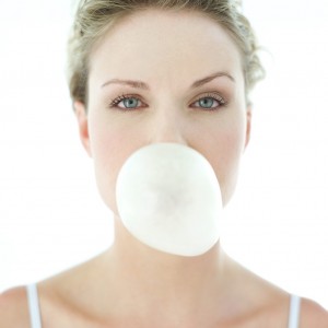 Young Woman Blowing a Chewing Gum Bubble